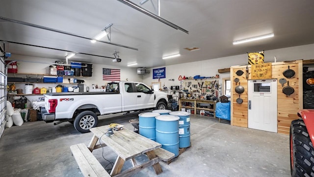 garage featuring a garage door opener and a workshop area