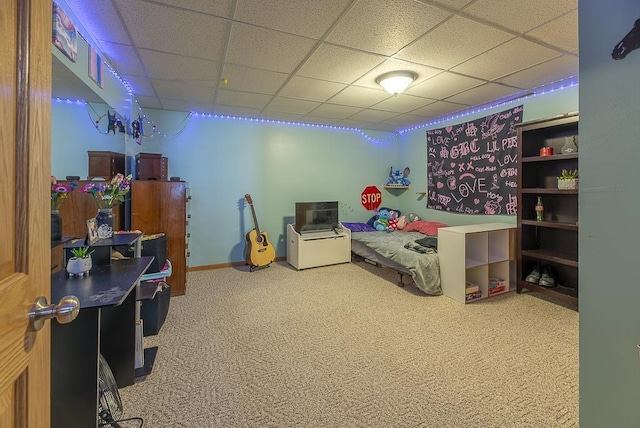bedroom featuring carpet floors and a drop ceiling