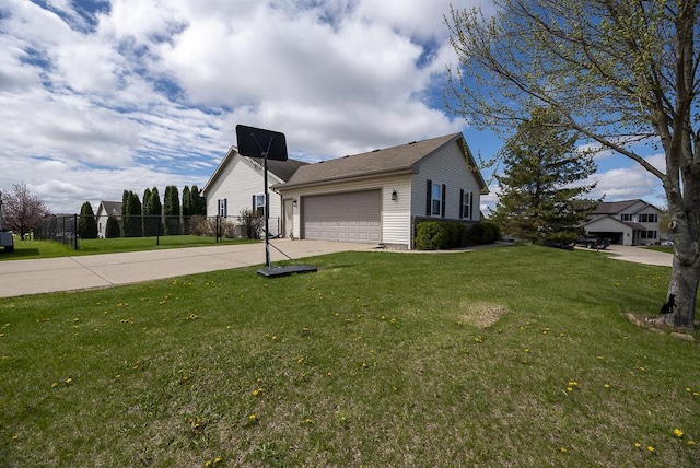 view of property exterior featuring fence, an attached garage, a yard, and driveway