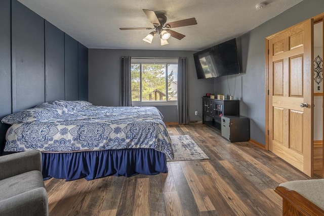 bedroom featuring baseboards, a ceiling fan, and wood finished floors