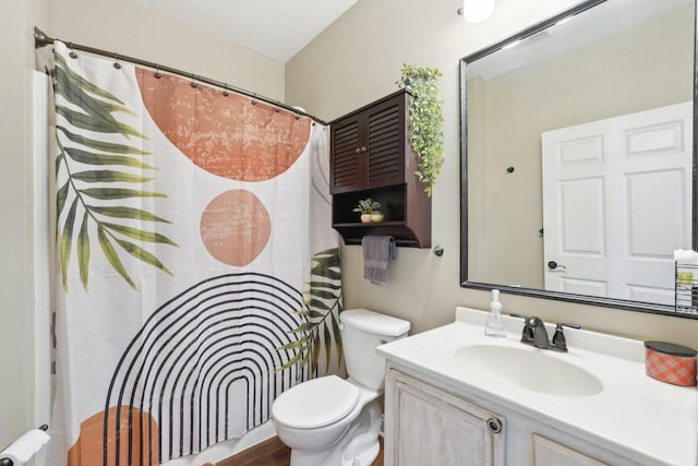 bathroom featuring vanity, toilet, and curtained shower