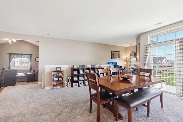 dining room with an inviting chandelier, visible vents, baseboards, and light carpet
