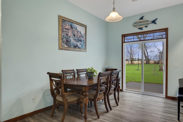 dining room with baseboards and wood finished floors