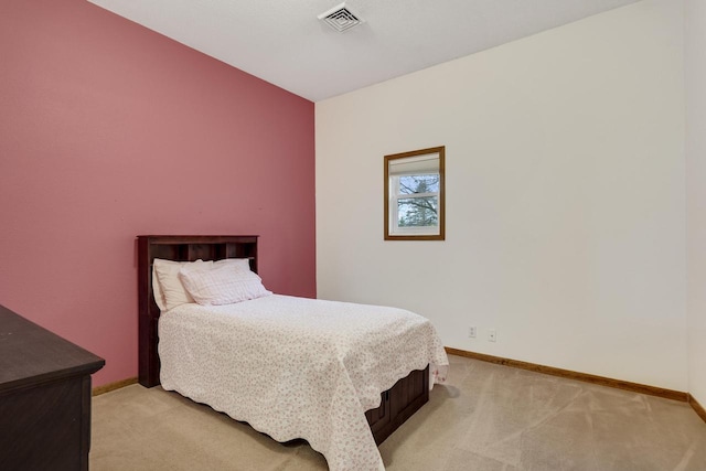 bedroom featuring baseboards, visible vents, and light carpet