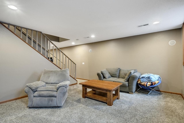 living room featuring baseboards, visible vents, stairway, and carpet flooring