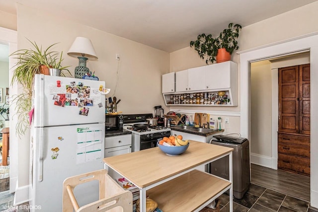 2968 N Buffum St Unit 2968A, Milwaukee, WI 53212 - kitchen with freestanding refrigerator, white cabinets, gas stove, black microwave, and a sink