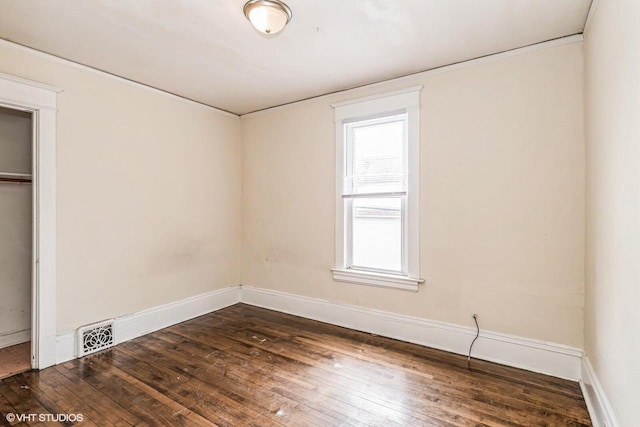2968 N Buffum St Unit 2968A, Milwaukee, WI 53212 - unfurnished bedroom with visible vents, a closet, dark wood-style floors, and baseboards