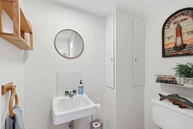 half bathroom with a sink and toilet