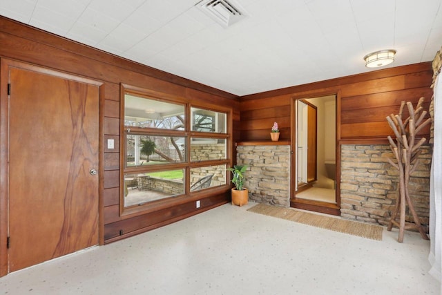 interior space with visible vents and wooden walls