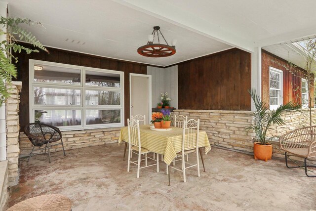 dining room featuring wooden walls