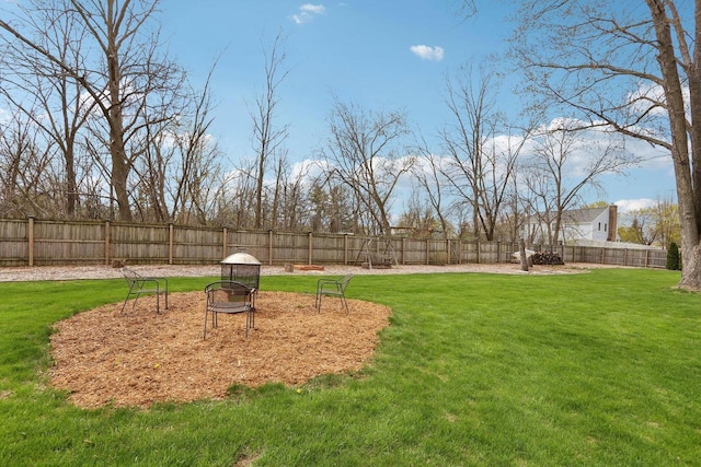 view of yard with a fenced backyard and an outdoor fire pit