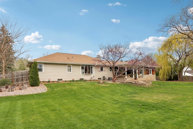 back of property featuring a lawn, fence, and a chimney
