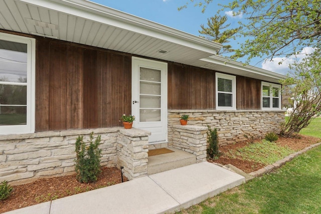 doorway to property with stone siding