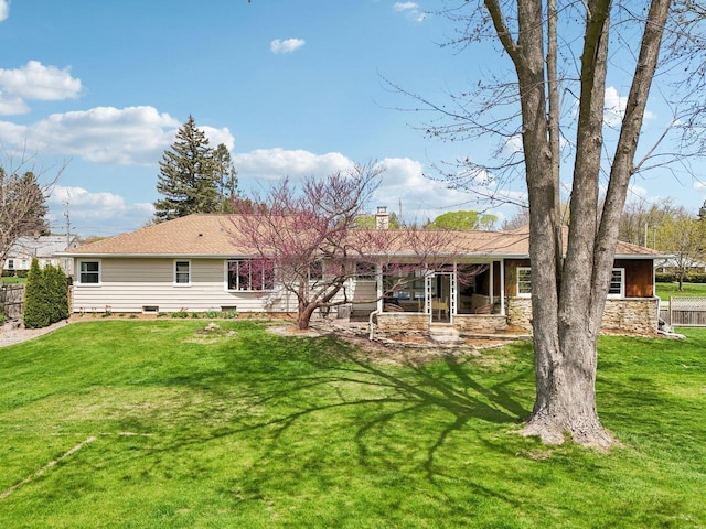 back of property featuring a lawn, crawl space, fence, and a chimney