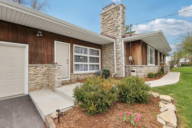 property entrance with a chimney and stone siding