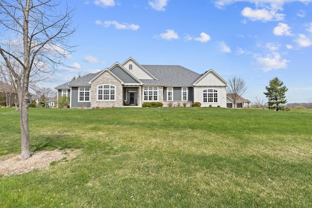 ranch-style house with a front lawn, roof with shingles, and stone siding