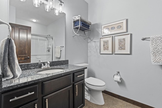 full bath featuring tile patterned flooring, vanity, toilet, baseboards, and a shower with shower door