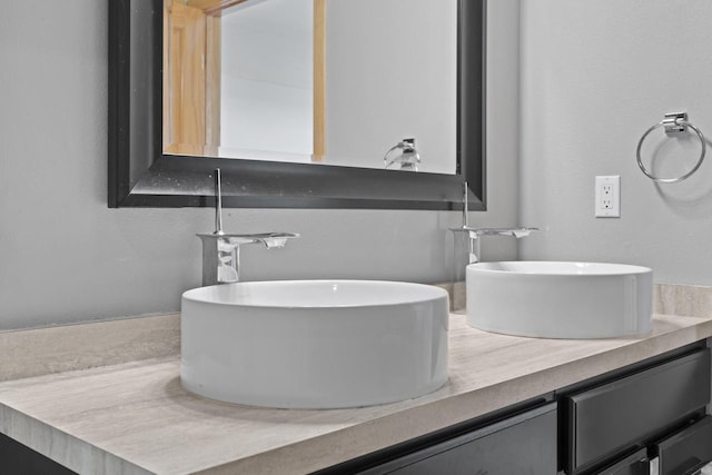 full bathroom featuring double vanity and a sink