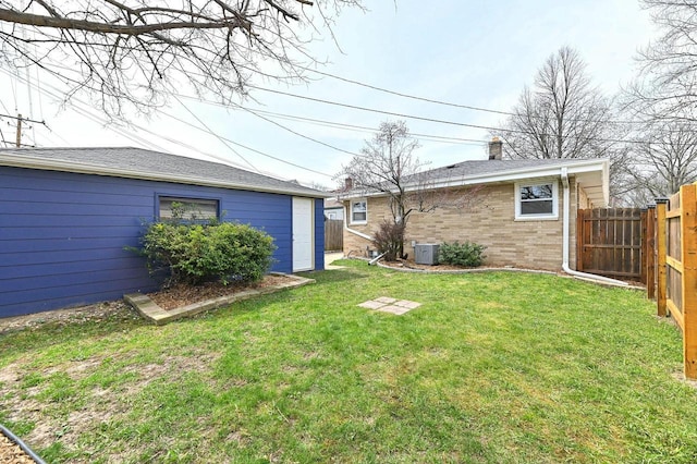 view of yard with fence and cooling unit