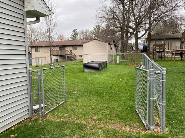 view of yard featuring fence and a gate