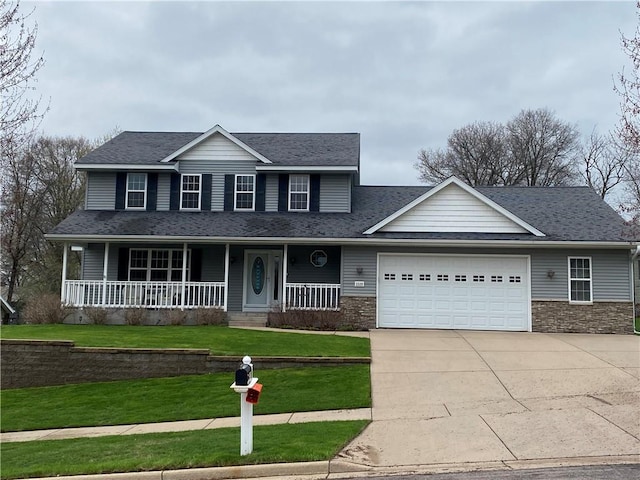 view of front of property featuring concrete driveway, roof with shingles, a front yard, an attached garage, and a porch