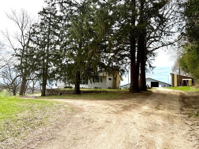 15497 Meiners Rd, Caledonia, MN 55921 - view of yard featuring an outdoor structure, a detached garage, and dirt driveway