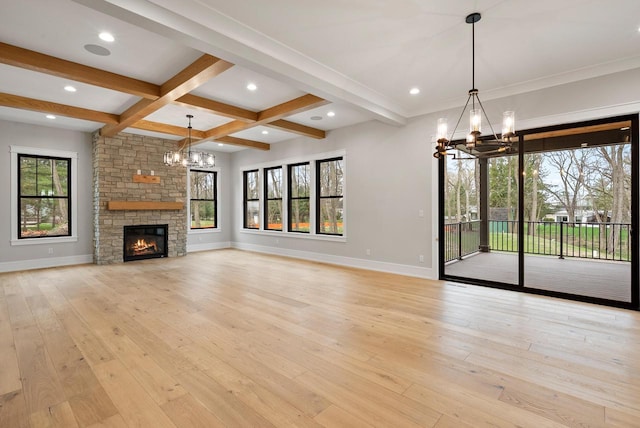 N1931 Linn Rd, Lake Geneva, WI 53147 - unfurnished living room with a healthy amount of sunlight, baseboards, and a chandelier