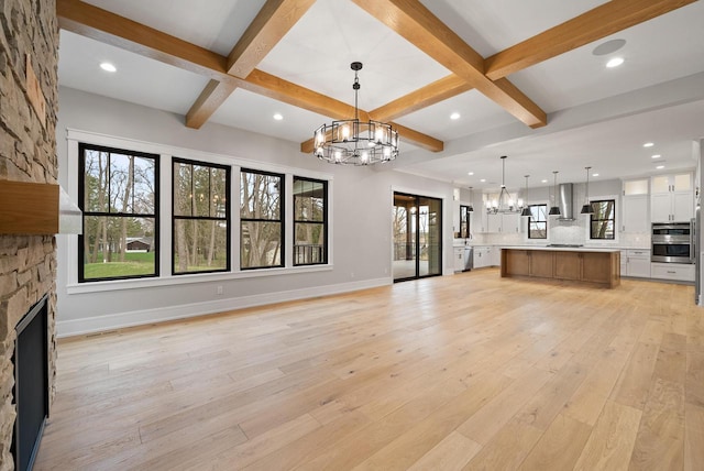 N1931 Linn Rd, Lake Geneva, WI 53147 - unfurnished living room featuring light wood-type flooring, coffered ceiling, a chandelier, and beamed ceiling