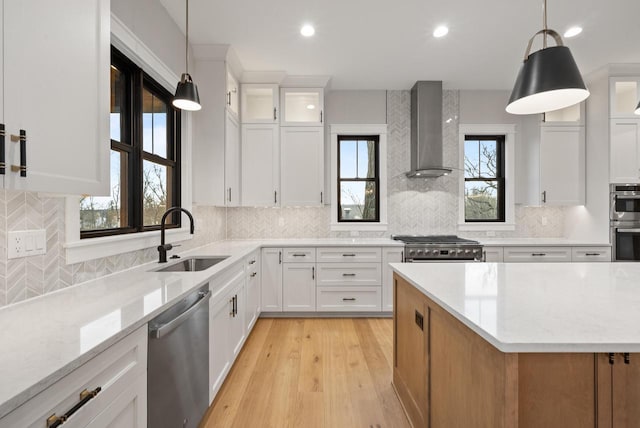 N1931 Linn Rd, Lake Geneva, WI 53147 - kitchen with decorative backsplash, wall chimney exhaust hood, white cabinetry, a sink, and appliances with stainless steel finishes