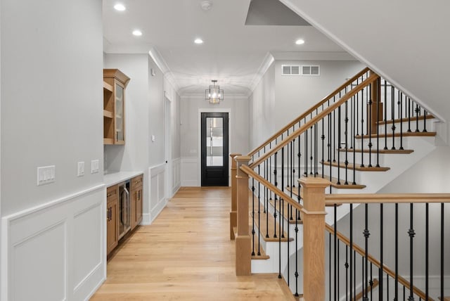 N1931 Linn Rd, Lake Geneva, WI 53147 - entrance foyer featuring visible vents, crown molding, an inviting chandelier, recessed lighting, and light wood-style flooring