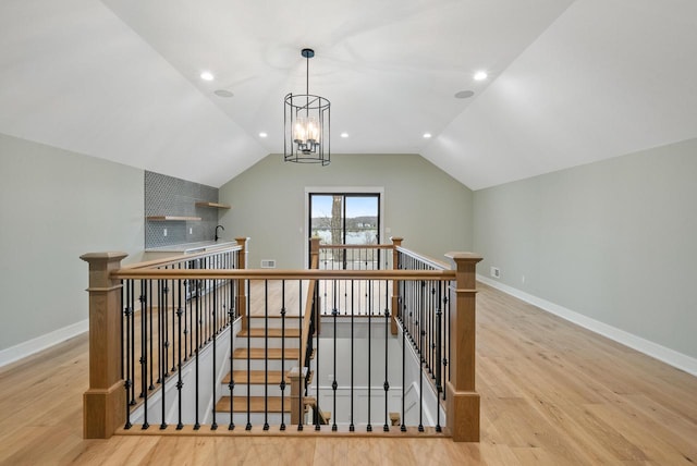 N1931 Linn Rd, Lake Geneva, WI 53147 - bonus room with visible vents, vaulted ceiling, baseboards, a notable chandelier, and light wood-style flooring