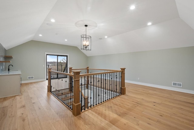 N1931 Linn Rd, Lake Geneva, WI 53147 - additional living space featuring visible vents, baseboards, lofted ceiling, and light wood-type flooring