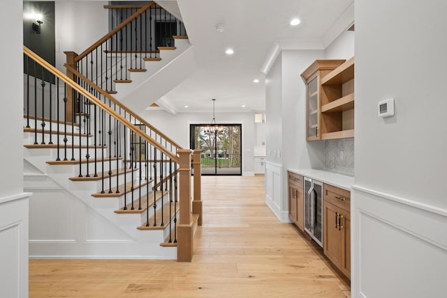 N1931 Linn Rd, Lake Geneva, WI 53147 - bar featuring a notable chandelier, beverage cooler, light wood-style flooring, recessed lighting, and backsplash