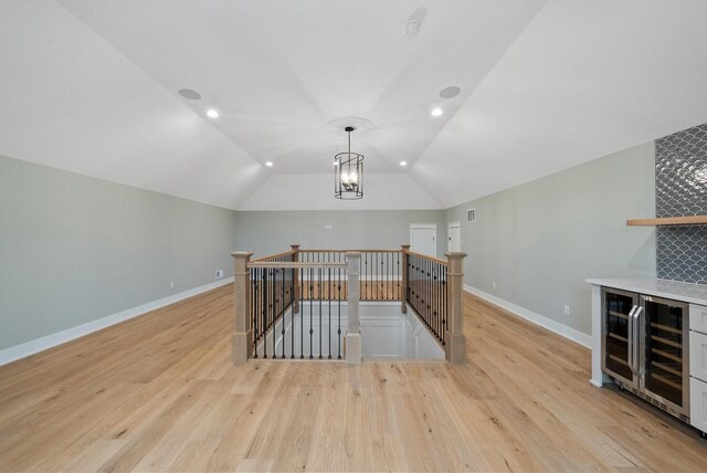 N1931 Linn Rd, Lake Geneva, WI 53147 - bonus room with baseboards, light wood finished floors, lofted ceiling, wine cooler, and recessed lighting