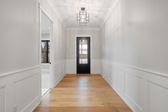 N1931 Linn Rd, Lake Geneva, WI 53147 - doorway with crown molding, wainscoting, light wood-style flooring, and a decorative wall