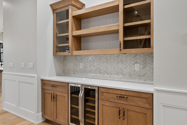N1931 Linn Rd, Lake Geneva, WI 53147 - bar with light wood-style floors, tasteful backsplash, a wainscoted wall, and wine cooler