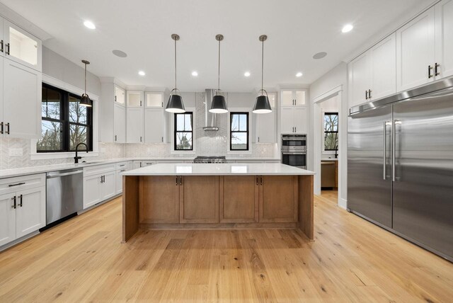N1931 Linn Rd, Lake Geneva, WI 53147 - kitchen with light countertops, a center island, backsplash, and stainless steel appliances