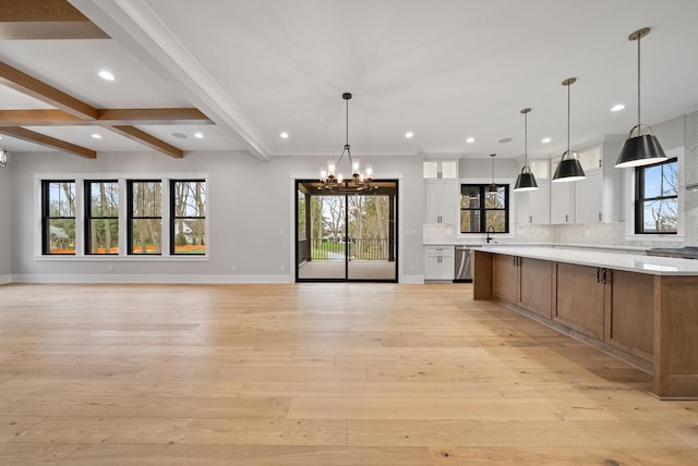 N1931 Linn Rd, Lake Geneva, WI 53147 - kitchen featuring stainless steel dishwasher, a notable chandelier, light countertops, white cabinets, and open floor plan
