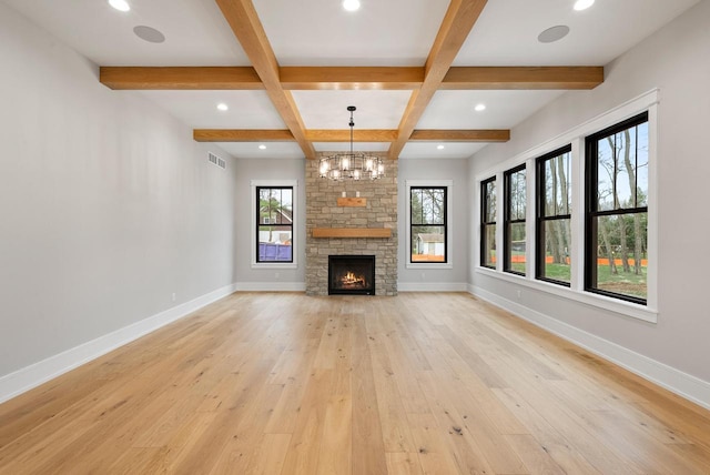 N1931 Linn Rd, Lake Geneva, WI 53147 - unfurnished living room featuring baseboards, visible vents, light wood finished floors, and coffered ceiling