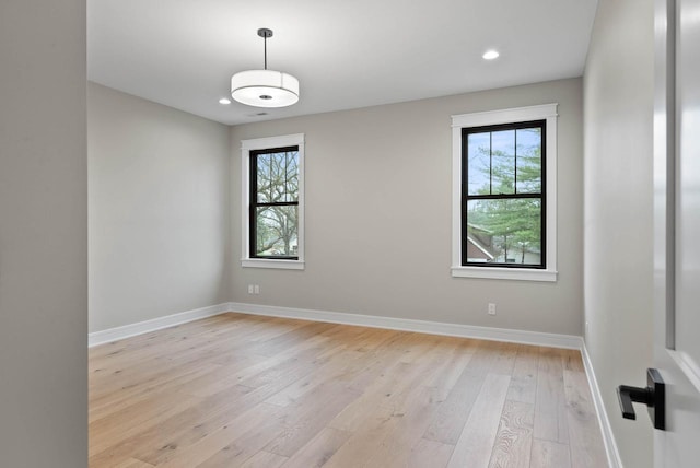 N1931 Linn Rd, Lake Geneva, WI 53147 - unfurnished room featuring recessed lighting, baseboards, a wealth of natural light, and light wood-style flooring