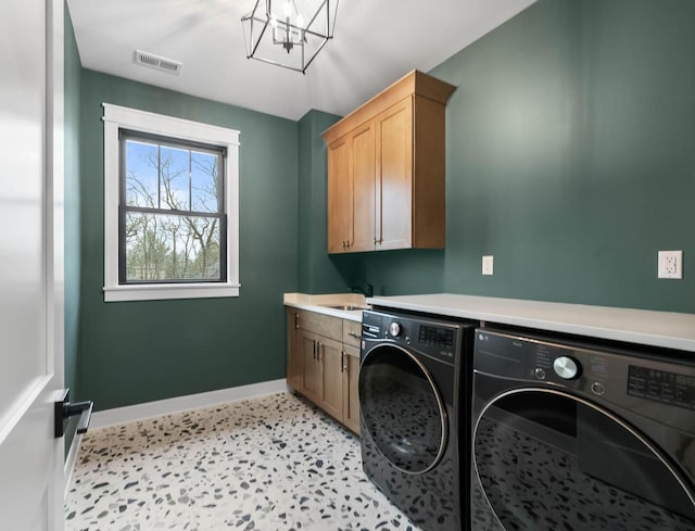 N1931 Linn Rd, Lake Geneva, WI 53147 - laundry room with visible vents, baseboards, washer and clothes dryer, a chandelier, and cabinet space