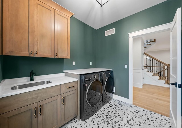 N1931 Linn Rd, Lake Geneva, WI 53147 - clothes washing area featuring visible vents, cabinet space, a sink, baseboards, and separate washer and dryer