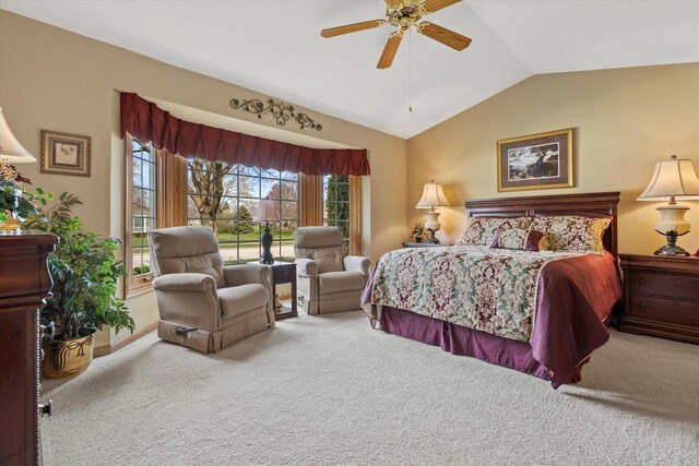 carpeted bedroom with ceiling fan, vaulted ceiling, and baseboards