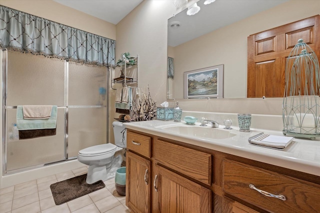 bathroom with a shower stall, toilet, tile patterned flooring, and vanity