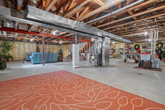 unfinished below grade area featuring heating unit and washer / clothes dryer