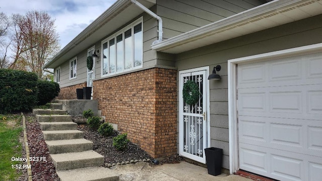 view of home's exterior featuring brick siding and a garage