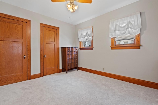 carpeted bedroom featuring a ceiling fan and baseboards