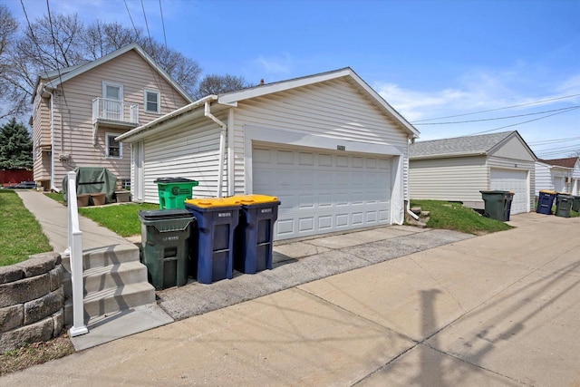 view of side of home with an outdoor structure and a detached garage