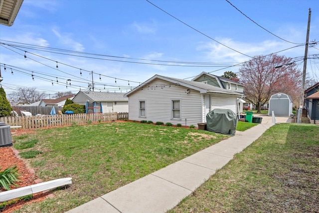 exterior space with fence, an outdoor structure, and a shed