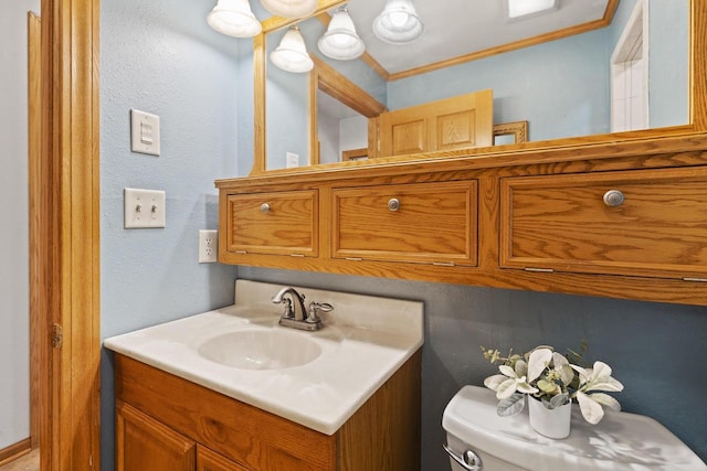 3559 N Shore Dr, Hubertus, WI 53033 - bathroom with vanity, toilet, and ornamental molding